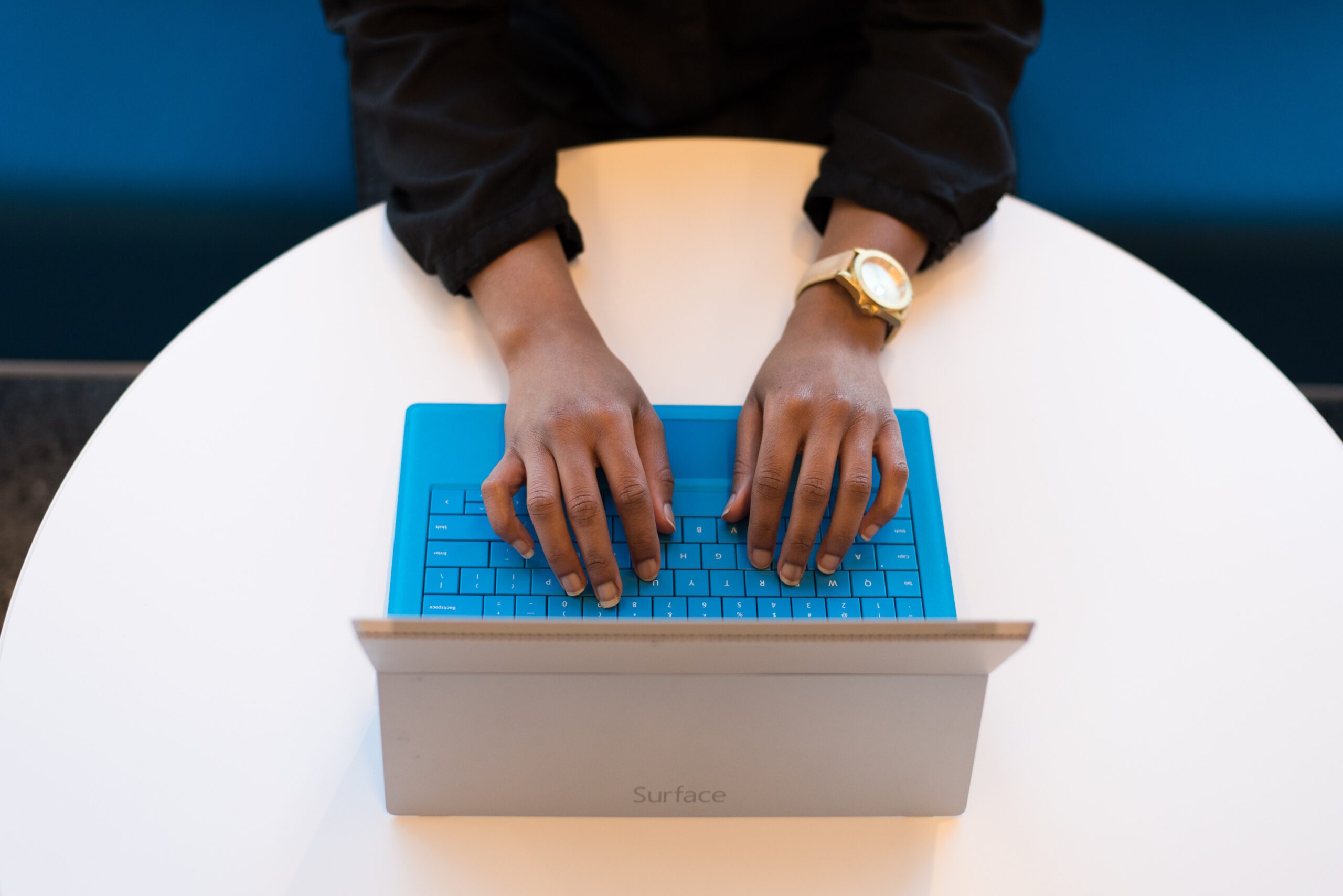 Vrouwelijke handen typend op een laptop.